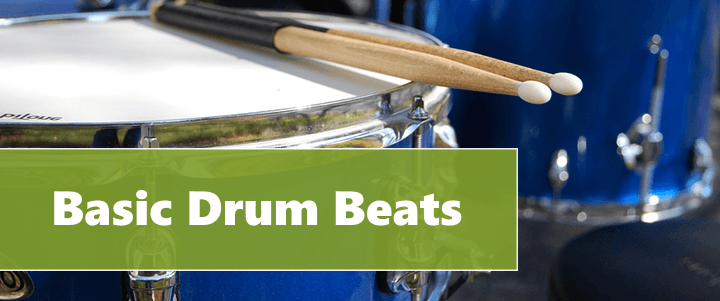 drum with 2 sticks on the head, it is header image of the article "Basic Drum Beats"