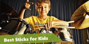 kid drum player holding a pair of drum sticks